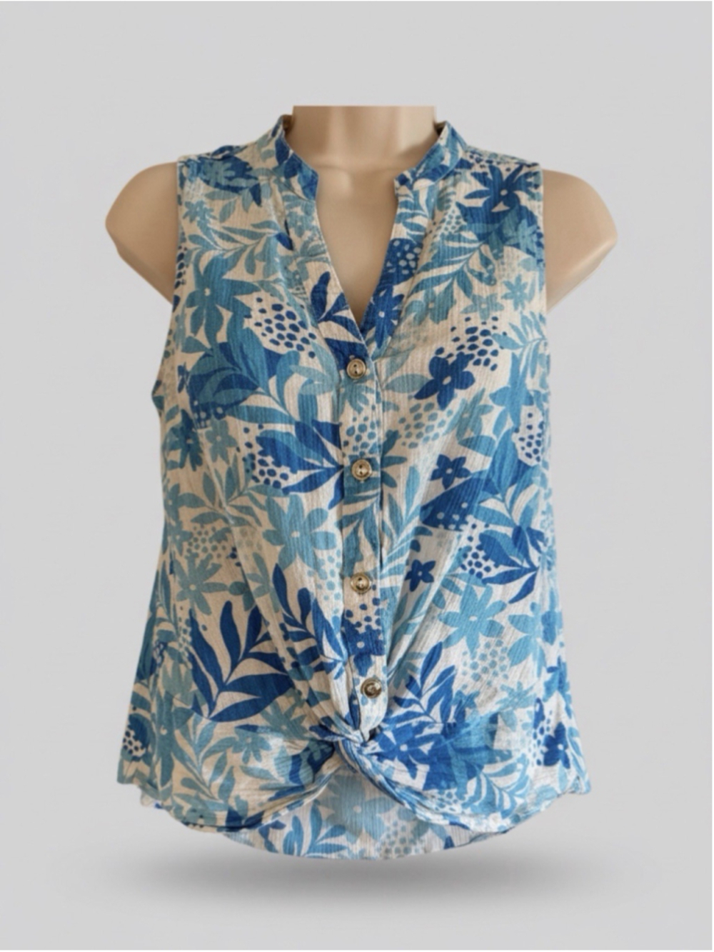 A Sleeveless V-neck (Or Split Neckline) Blouse Featuring A Vibrant Allove Print
